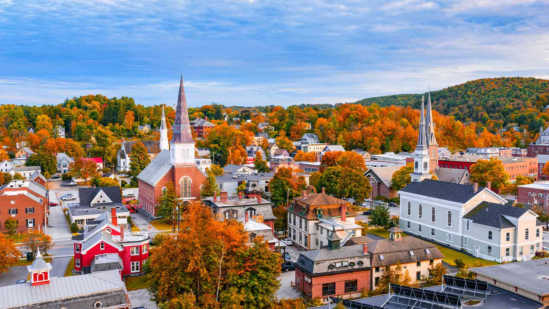 Skyline of Montpelier, Vermont with bright autumn leaves on a sunny day